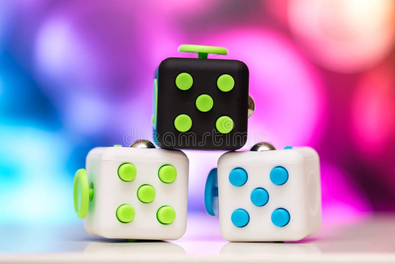 Fidget Cube Anti Stress Toy Detail Of Finger Play Toy Used For Relax Gadget  Placed On Colorful Bokeh Background Stock Photo - Download Image Now -  iStock