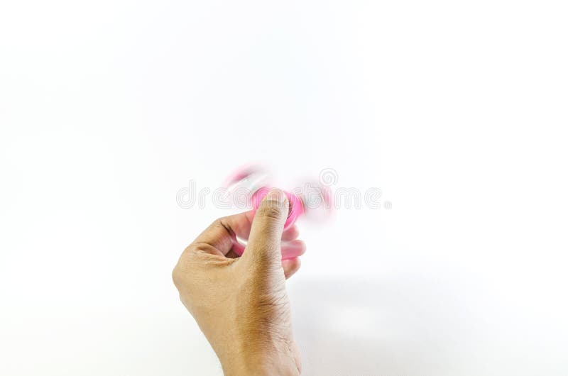 A moving fidget spinner on a human hand. stock photo