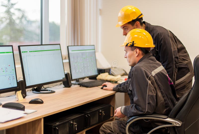 Field service engineers inspect relay protection system with lap royalty free stock photos