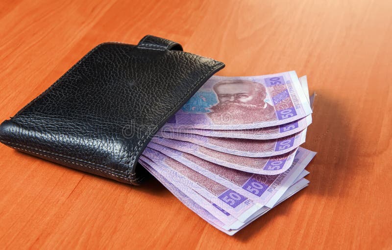 Fifty Ukrainian hryvnia banknotes in black purse