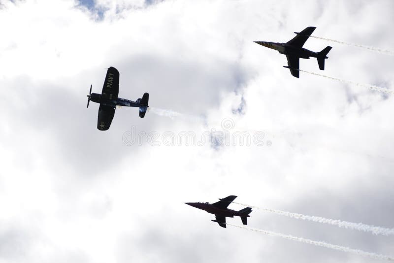 Fighter jets on grey sky with old timer