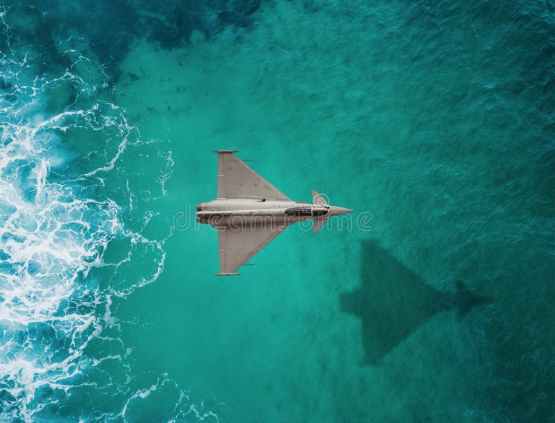 Fighter plane flies over a sea