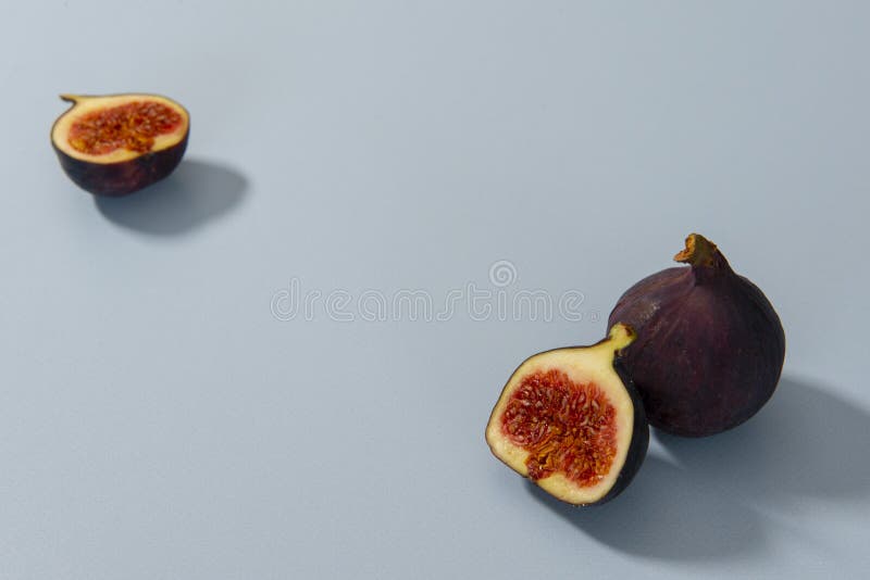 Figs Halved on a Blue Background Stock Image Image of slices, flower