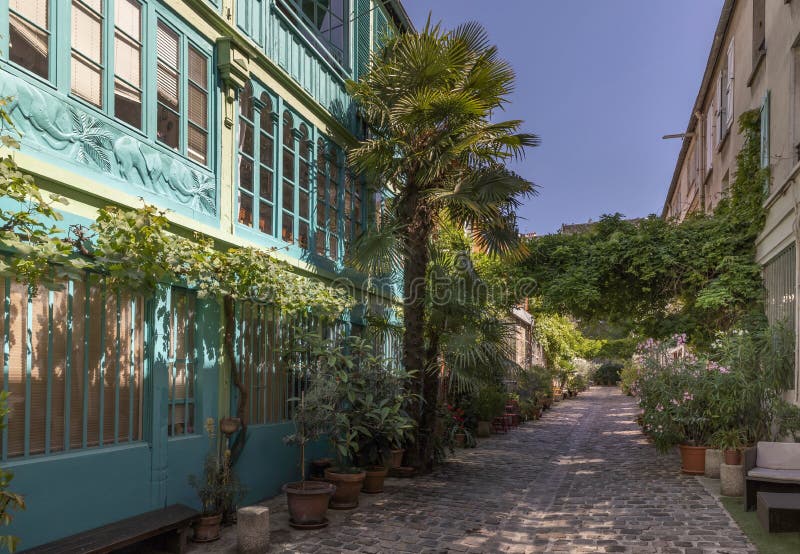 Paris, France - June 24, 2020: The Figuier street with its vegetation in Paris 11th district. Paris, France - June 24, 2020: The Figuier street with its vegetation in Paris 11th district