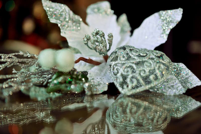 Shining figure of heart and white flower reflected on the glass