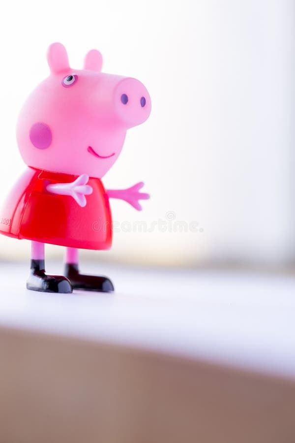 A plastic Peppa Pig toy play house standing on a table Stock Photo