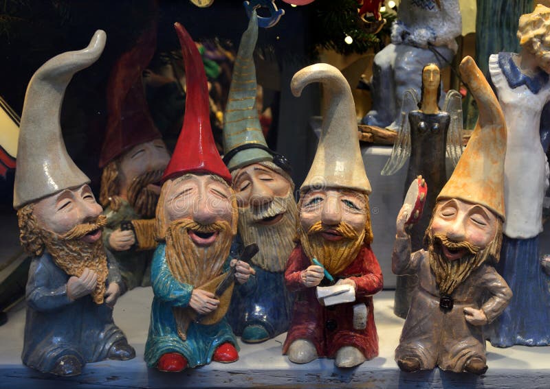 Figures of cheerful gnomes in multi-colored hats stock photos