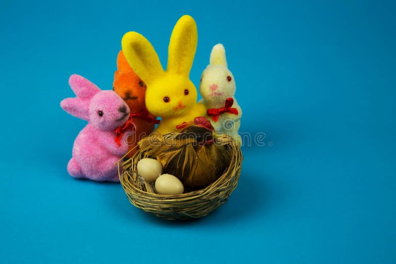 Figurines Easter bunnies and hen on a nest stock image Figurines Easter bunnies and hen on a nest stock image