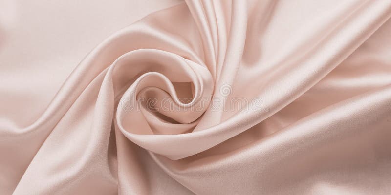 Delicate smooth soft pink silk bedsheet, abstract fabric background with waves. Beige shiny textile texture. Satin folds, luxury fashion. Glossy clothes. Delicate smooth soft pink silk bedsheet, abstract fabric background with waves. Beige shiny textile texture. Satin folds, luxury fashion. Glossy clothes.