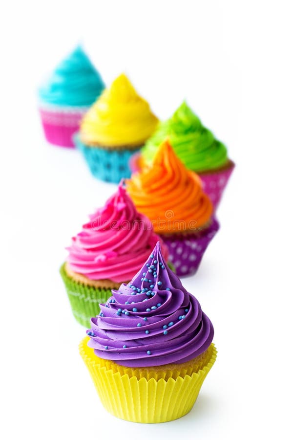 Row of colorful cupcakes against white. Row of colorful cupcakes against white