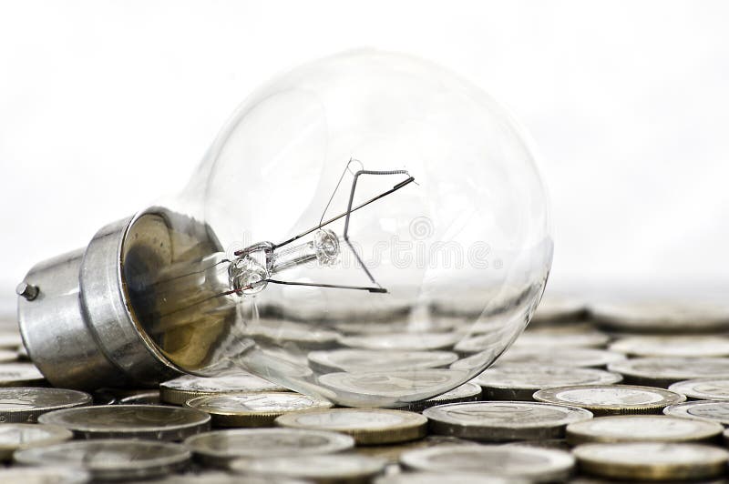 Filament bulb lying on coins