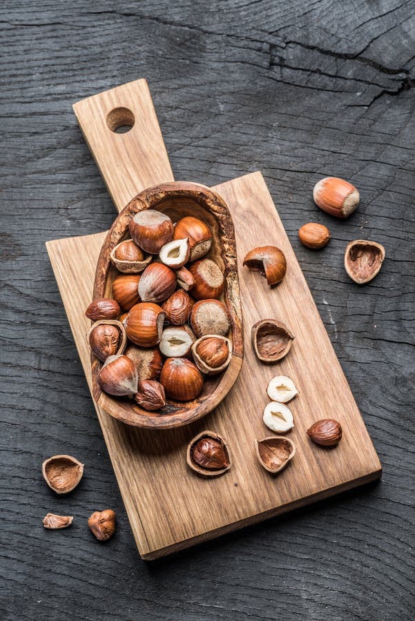 Filberts or hazelnuts in the wooden bowl on the table.