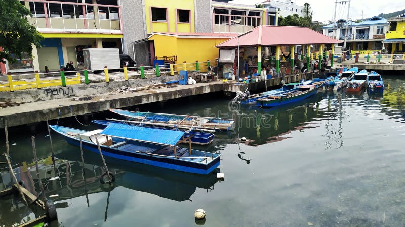 Rows of small boats belonging to fishermen anchored at the mouth of the city of Ternate, Indonesia. Rows of small boats belonging to fishermen anchored at the mouth of the city of Ternate, Indonesia