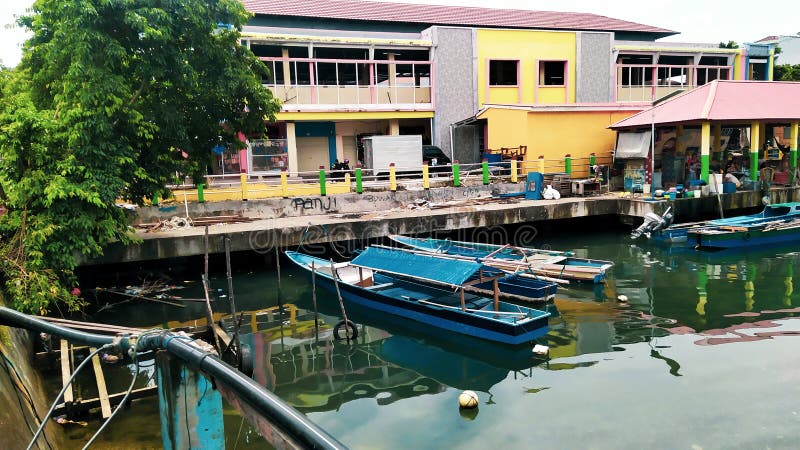 Rows of small boats belonging to fishermen anchored at the mouth of the city of Ternate, Indonesia. Rows of small boats belonging to fishermen anchored at the mouth of the city of Ternate, Indonesia