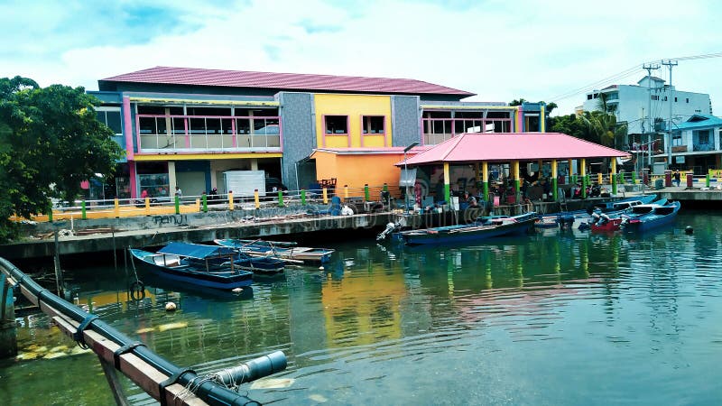 Rows of small boats belonging to fishermen anchored at the mouth of the city of Ternate, Indonesia. Rows of small boats belonging to fishermen anchored at the mouth of the city of Ternate, Indonesia