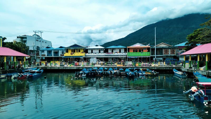 Rows of small boats belonging to fishermen anchored at the mouth of the city of Ternate, Indonesia. Rows of small boats belonging to fishermen anchored at the mouth of the city of Ternate, Indonesia
