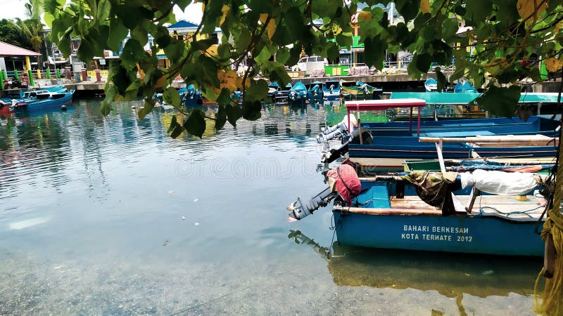 Rows of small boats belonging to fishermen anchored at the mouth of the city of Ternate, Indonesia. Rows of small boats belonging to fishermen anchored at the mouth of the city of Ternate, Indonesia