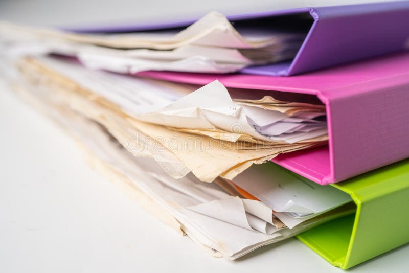 File Folder Binder stack of multi color on table.