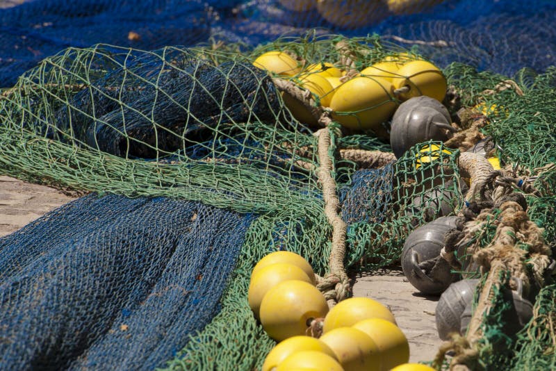 Green and blue fishing nets and yellow floats. Green and blue fishing nets and yellow floats