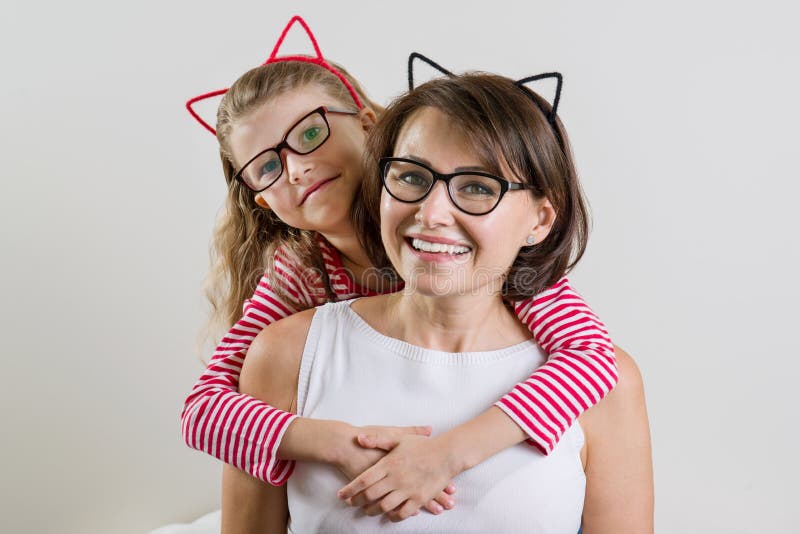 A filha abraça lovingly sua mãe Pai e criança nos vidros fotografia de stock A filha abraça lovingly sua mãe Pai e criança nos vidros fotografia de stock
