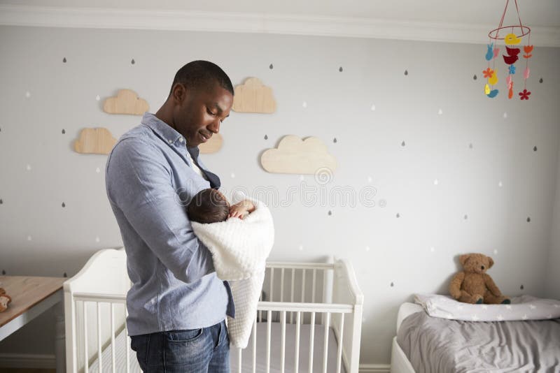 Father Holding Newborn Baby Son In Nursery. Father Holding Newborn Baby Son In Nursery