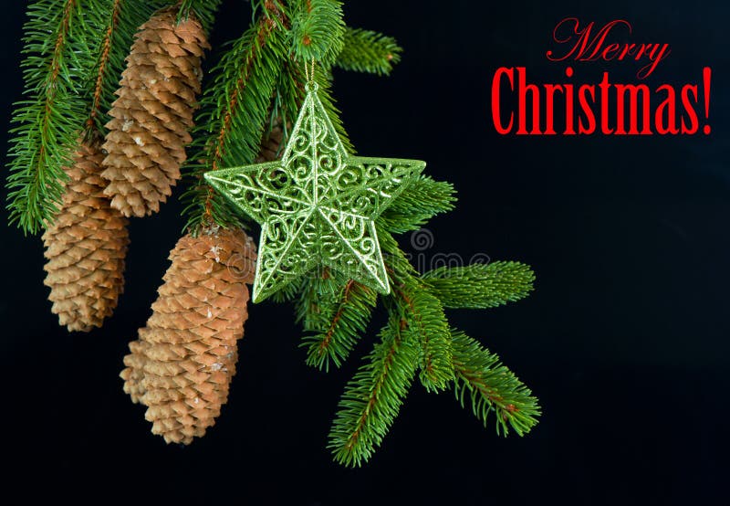 Merry christmas! card concept. fir tree branch with shiny star decoration over black. Merry christmas! card concept. fir tree branch with shiny star decoration over black