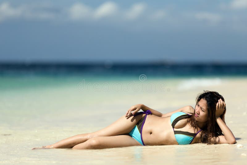 Filipina woman lying on the seashore. Filipina woman lying on the seashore