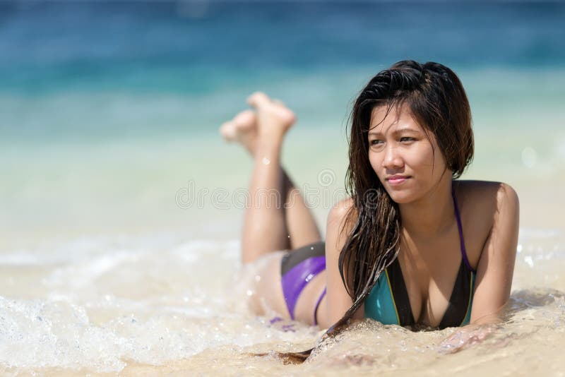 Filipina woman lying on the seashore in a sunny day. Filipina woman lying on the seashore in a sunny day