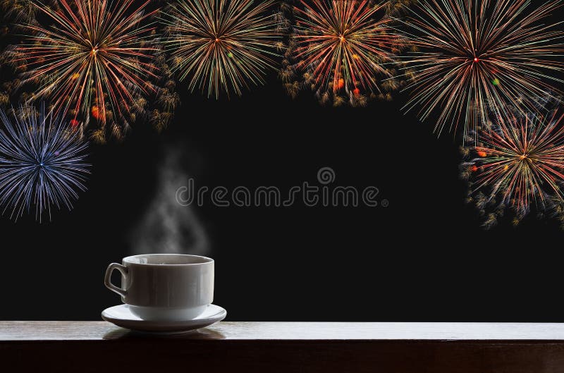 Cup of hot drinks on wood desk with new year celebrate fireworks on night sky. Cup of hot drinks on wood desk with new year celebrate fireworks on night sky