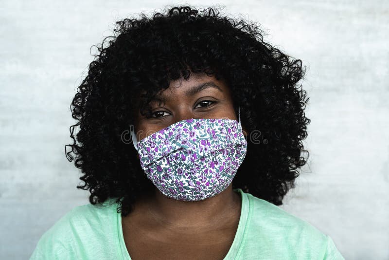 Happy African woman portrait - Afro girl wearing protective face mask for preventing spread of corona virus - Health care people concept. Happy African woman portrait - Afro girl wearing protective face mask for preventing spread of corona virus - Health care people concept
