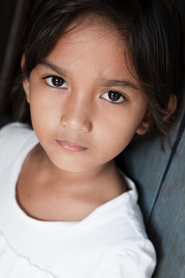 Portrait of a pretty young girl from the Philippines against a wall. Portrait of a pretty young girl from the Philippines against a wall