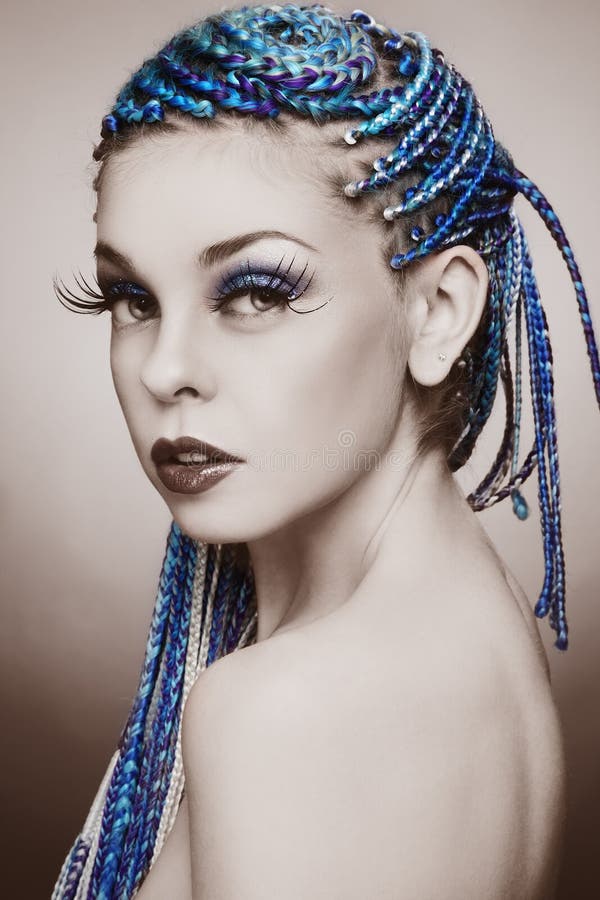 Sepia coloured portrait of young beautiful girl with blue braids and huge fancy fake eyelashes. Sepia coloured portrait of young beautiful girl with blue braids and huge fancy fake eyelashes