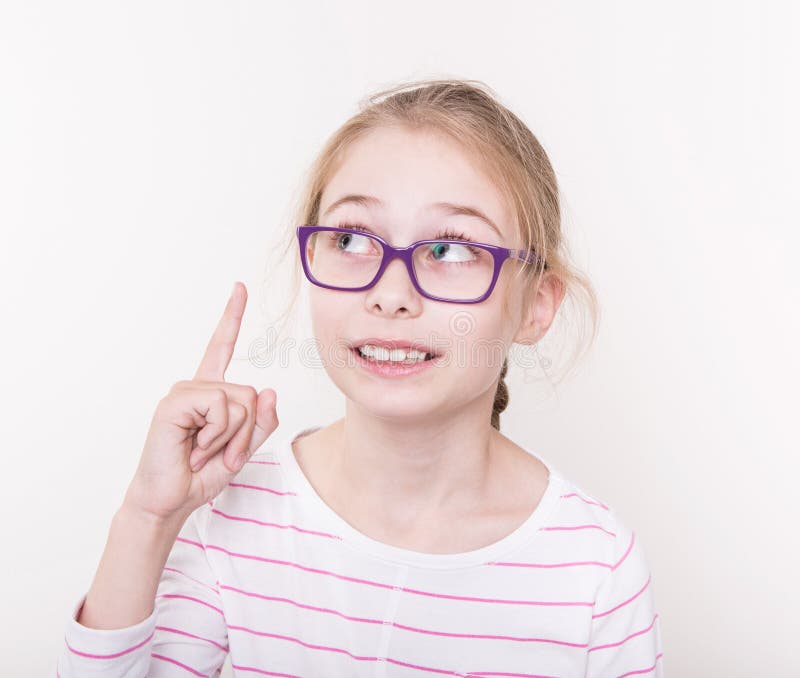 Fille blonde d'enfant en verres violets dirigeant le doigt photographie stock libre de droits Fille blonde d'enfant en verres violets dirigeant le doigt photographie stock libre de droits