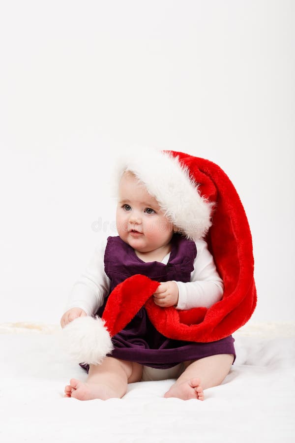 Fille d'enfant avec le chapeau de Santa de Noël images libres de droits Fille d'enfant avec le chapeau de Santa de Noël images libres de droits