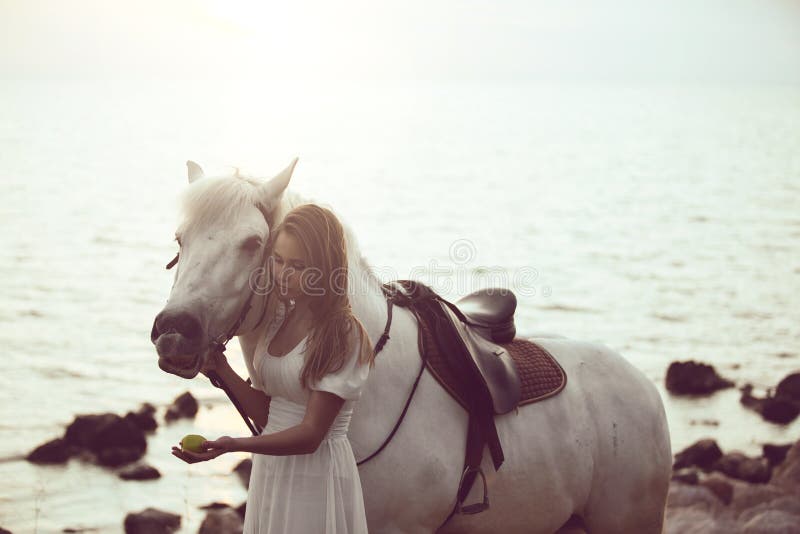 Fille Dans La Robe Blanche Avec Le Cheval Sur La Plage Image stock