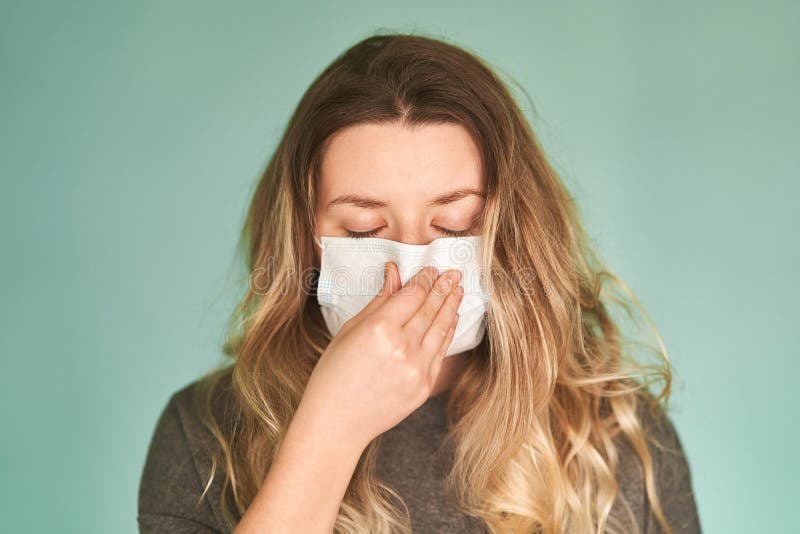 Girl in a medical mask on a green background. Coronavirus. Prevention of viral diseases. Girl in a medical mask on a green background. Coronavirus. Prevention of viral diseases.