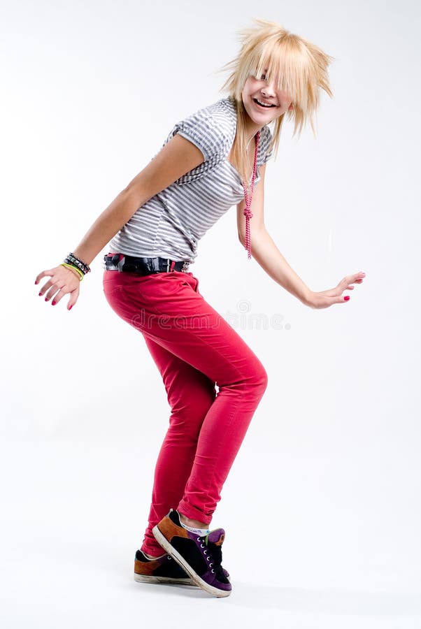 Funky teenage blonde emo girl dancing at white background. Funky teenage blonde emo girl dancing at white background