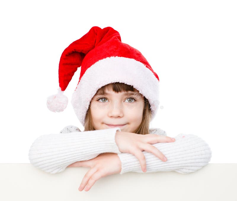 Fille de Noël heureux avec le chapeau de Santa derrière le conseil blanc D'isolement images stock Fille de Noël heureux avec le chapeau de Santa derrière le conseil blanc D'isolement images stock