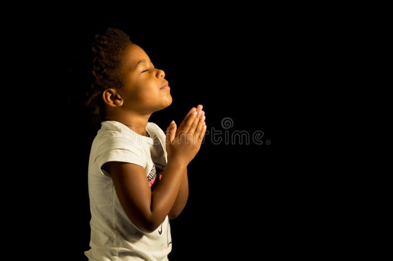 A young child prays to God. A young child prays to God.