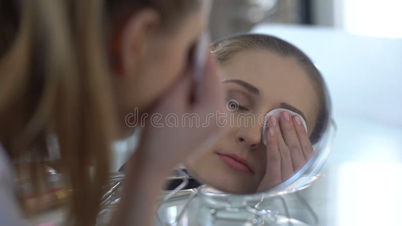 Fille enlevant facilement le maquillage des yeux avec la nouvelle lotion, essai des solvants clips vidéos