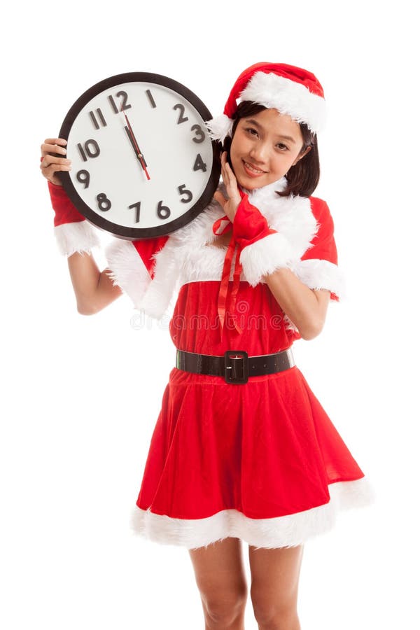 Fille et horloge asiatiques de Santa Claus de Noël à minuit