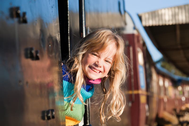 A cute girl looking out from a train window. A cute girl looking out from a train window.