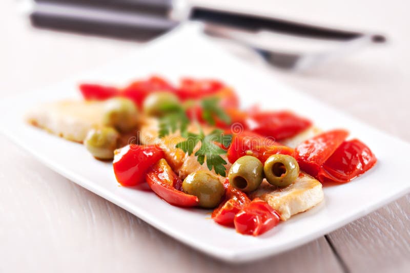 Fillet of halibut with tomatoes and olives stock photography