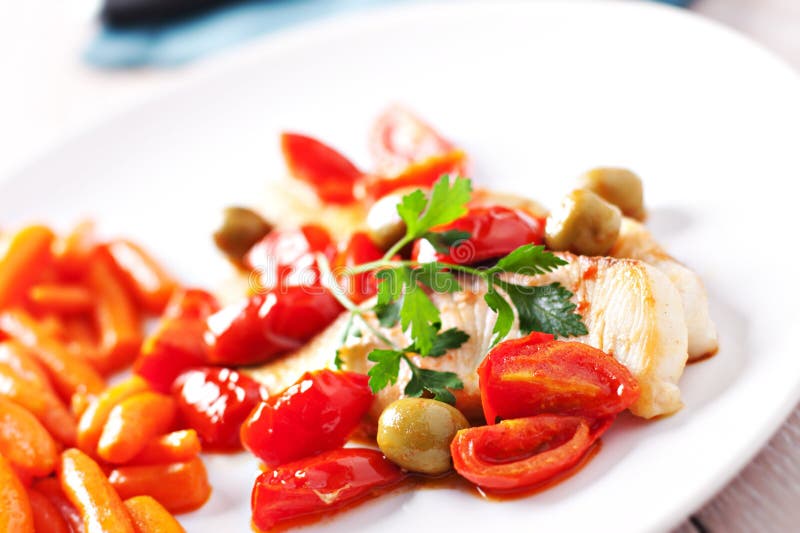 Fillet of halibut with tomatoes and olives stock photos