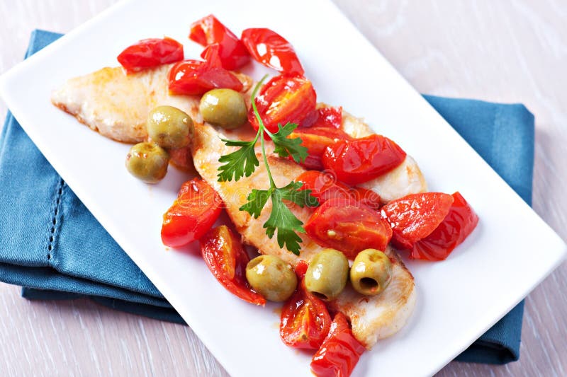 Fillet of halibut with tomatoes and olives royalty free stock photography