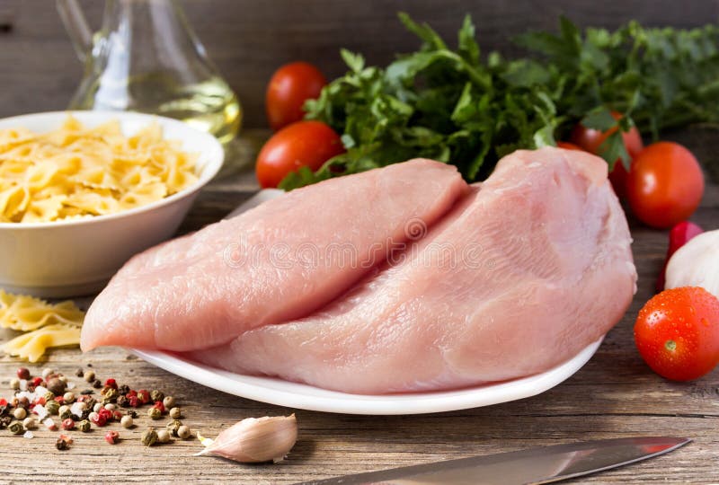 Fillet of Turkey with Tomatoes, Parsley and Paste on the Table. Stock