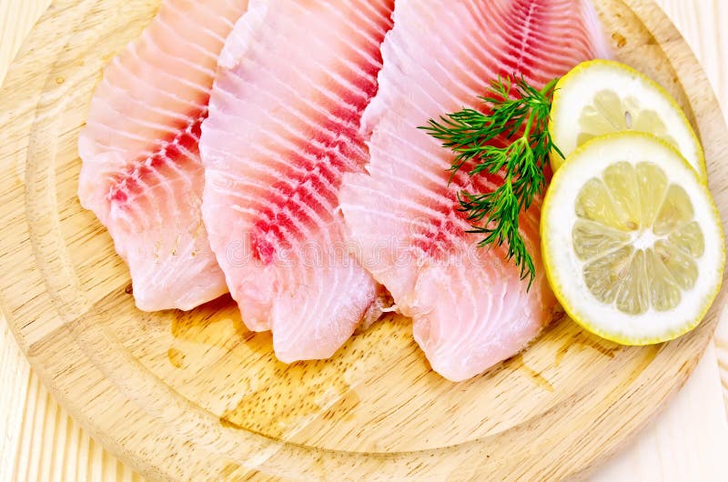 Fillets tilapia on a round board royalty free stock image Fillets tilapia on a round board royalty free stock image
