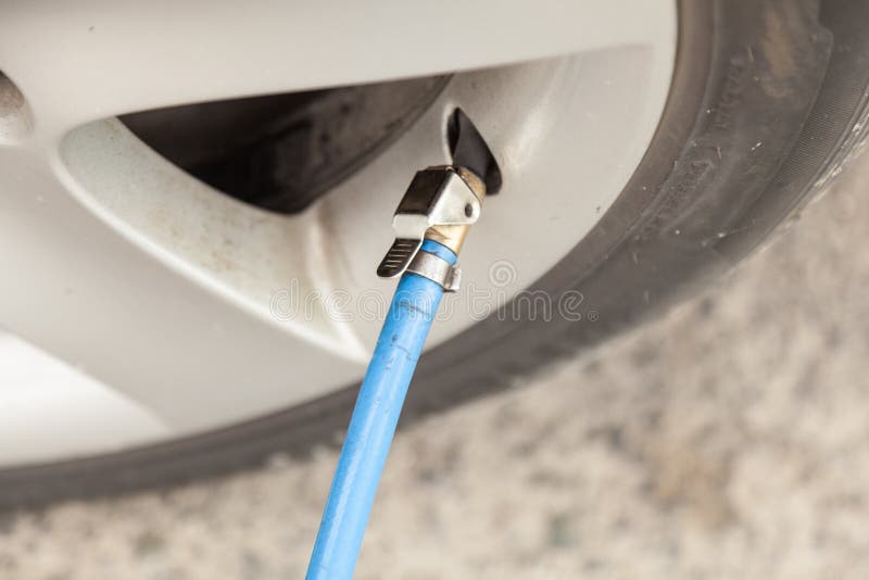 Filling air into a tire stock image. Image of inflated 96840109