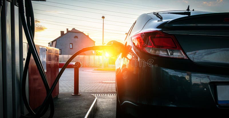 Filling car petrol. Pump gas fuel at gasoline oil station for nozzle tank. Black handle of the refueling gun.