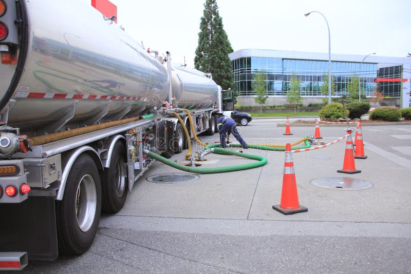 Filling Gas Station Fuel Tanks. A truck with two containers carrying gasoline is used to refill holding tanks at a commercial gasoline station royalty free stock image Filling Gas Station Fuel Tanks. A truck with two containers carrying gasoline is used to refill holding tanks at a commercial gasoline station royalty free stock image